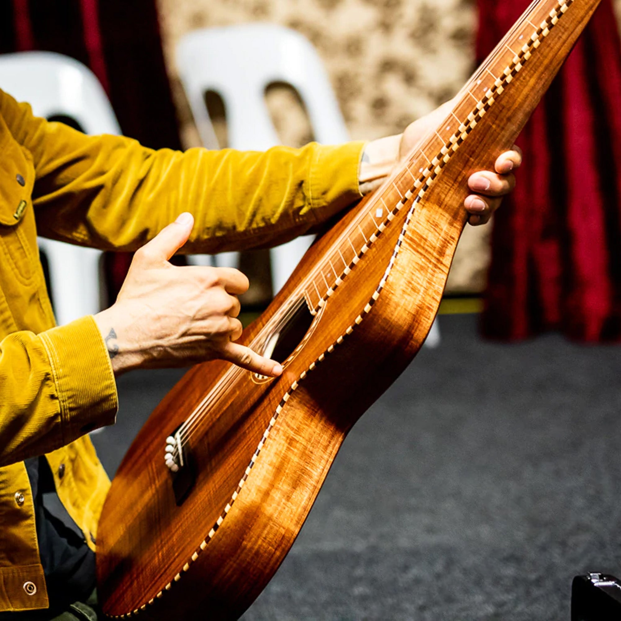 Ben Harper points at a custom Richard Wilson Style 3 Weissenborn gifted to him